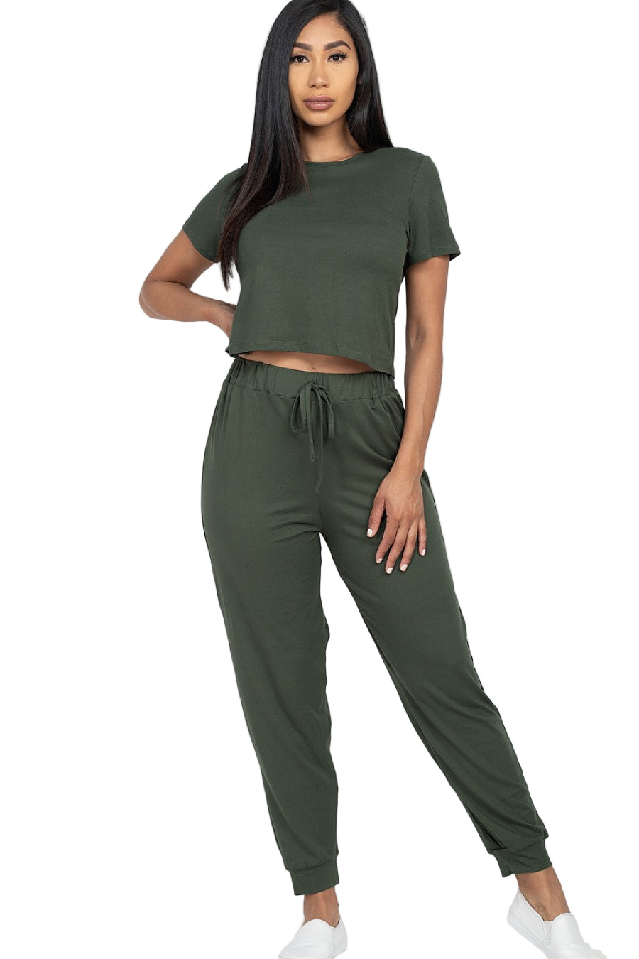 Woman wearing olive green solid basic loose short sleeve top and pants set, showcasing soft, stretchy jersey fabric with elastic waistband.